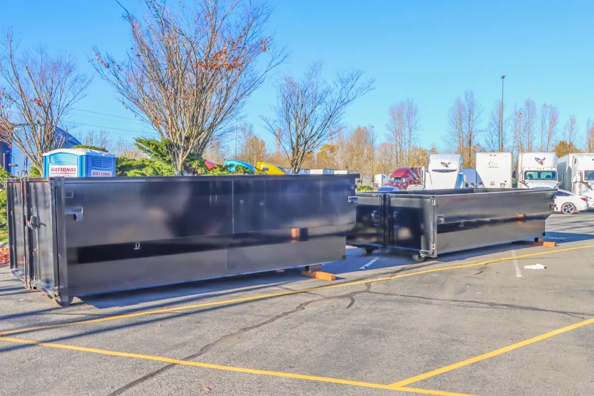 Professional dumpster rental service with roll-off container on residential driveway in Galveston